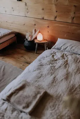 a bedroom with a bed and a wooden wall at 4 bedroom house for 8 guests in Brülisau
