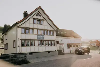 a building with a car parked in front of it at Quiet exclusive house for 6 people in Brülisau