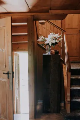 a vase of flowers on a table in a room at Quiet exclusive house for 6 people in Brülisau