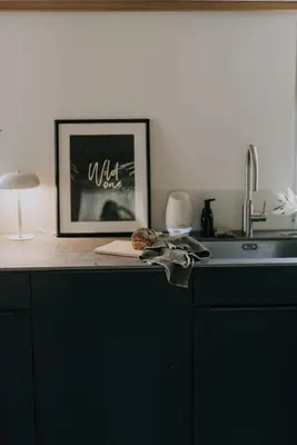 a kitchen counter with a picture and a sink at Zimmer Fählensee im Appenzeller Ferienhaus in Brülisau