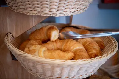 a basket full of croissants on a table at Hotel Garni Rössli in St. Gallen