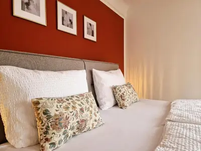 a bedroom with a bed with two pillows on it at FEWOCASA Central Family Apartment Rorschach - Lake Constance - 15 min OLMA in Rorschach