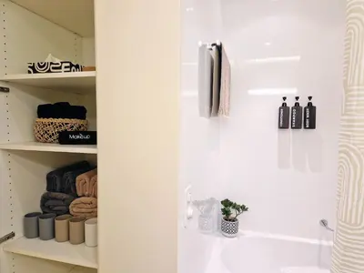 a bathroom with a sink and a shelf with bottles at FEWOCASA Central Family Apartment Rorschach - Lake Constance - 15 min OLMA in Rorschach