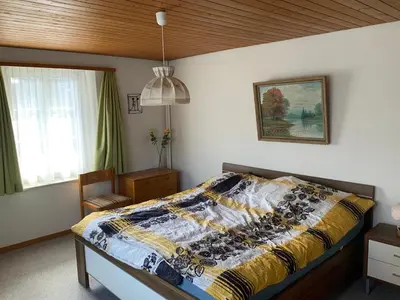 a bedroom with a bed with a quilt on it at Appenzellerland Schöne Wohnung in einem Wandergebiet in Teufen