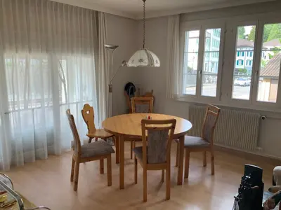 a dining room with a wooden table and chairs at Appenzellerland Schöne Wohnung in einem Wandergebiet in Teufen