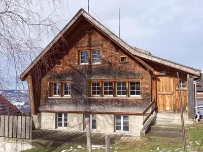 a large wooden house with windows on top at Holiday Home Ferienhaus- - Stöckli Klingenbuch 20 by Interhome in Rehetobel