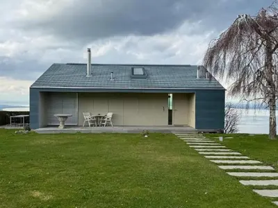 a blue house with a table and chairs in a yard at Holiday Home Unterbilchen by Interhome in Eggersriet