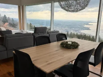 a dining room with a table and a large window at Holiday Home Unterbilchen by Interhome in Eggersriet