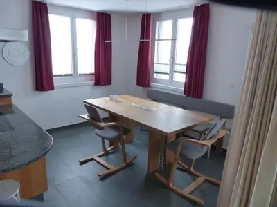 a dining room with a wooden table and chairs at Apartment Moderne FeWo by Interhome in Appenzell
