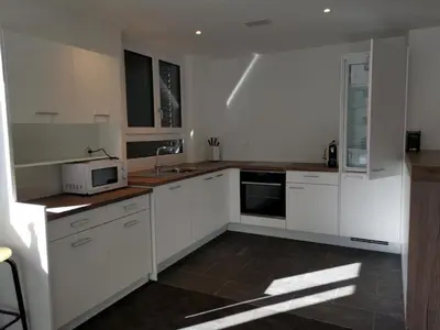a kitchen with white cabinets and a microwave at Apartment HIRSCHEN by Interhome in Gossau