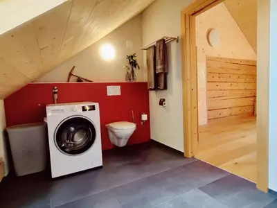 a bathroom with a washing machine and a toilet at Apartment Bauernhaus VordereAu by Interhome in Schwellbrunn