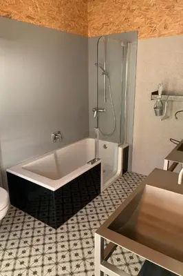 a bathroom with a bath tub and a shower at Apartment nirkwerk by Interhome in Schönengrund
