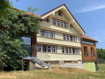 a large house with a staircase in front of it at Apartment nirkwerk by Interhome in Schönengrund