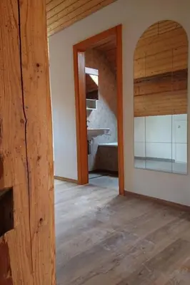 a room with a wooden floor and a mirror at Apartment Alpen-Paradies Edelweiss Urnäsch by Interhome in Urnäsch