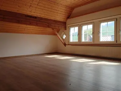 an empty room with windows and a wooden ceiling at Apartment Alpen-Paradies Edelweiss Urnäsch by Interhome in Urnäsch