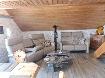 a living room with two couches and a table at Apartment Alpen-Paradies Edelweiss Urnäsch by Interhome in Urnäsch