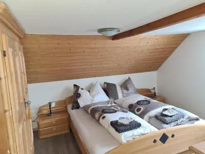 a bedroom with a bed with pillows on it at Apartment Alpen-Paradies Edelweiss Urnäsch by Interhome in Urnäsch