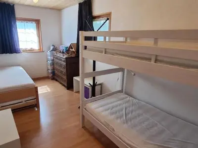a room with a bunk bed and a bedroom with a bunk bed at Apartment Tiererlebnishof Windegg by Interhome in Urnäsch