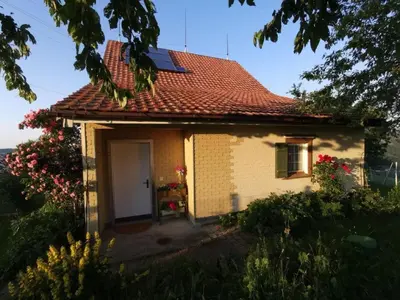 a small yellow house with a red roof at Apartment Tiererlebnishof Windegg by Interhome in Urnäsch