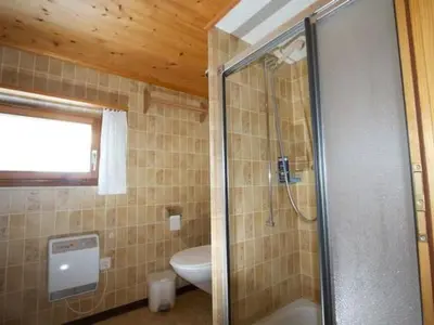 a bathroom with a shower with a toilet and a sink at Apartment Hasenbüel by Interhome in Ricken