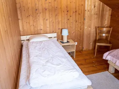 a bedroom with a bed in a wooden cabin at Holiday Home Hörli by Interhome in Sankt Peterzell