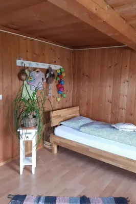 a room with two beds in a wooden cabin at Holiday Home Haus Chrumis by Interhome in Sankt Peterzell