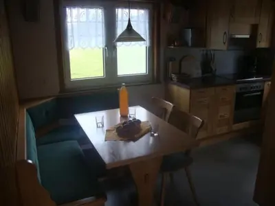 a kitchen with a wooden table with chairs and a dining room at Holiday Home Alten-Hof by Interhome in Bischofszell