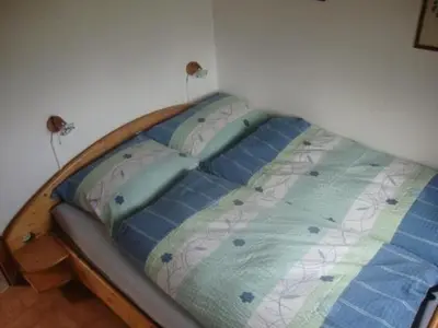 a bed in the corner of a bedroom at Holiday Home Alten-Hof by Interhome in Bischofszell