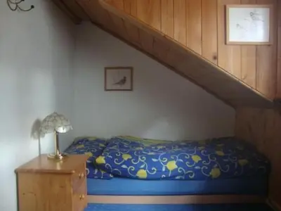 a bed in a room with a staircase at Holiday Home Alten-Hof by Interhome in Bischofszell