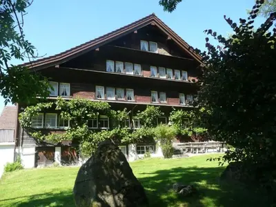 a building with a rock in front of it at Holiday Home Frohheim by Interhome in Sankt Peterzell