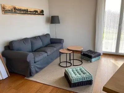 a living room with a blue couch and a table at Apartment Seehof by Interhome in Rorschacherberg