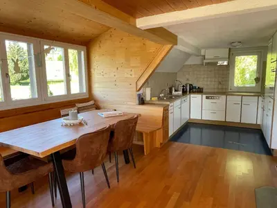 a large kitchen with a wooden table and chairs at Apartment Wartheim by Interhome in Heiden