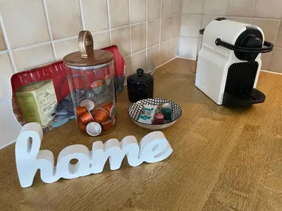 a wooden counter top with a home sign and a toaster at Apartment Wartheim by Interhome in Heiden