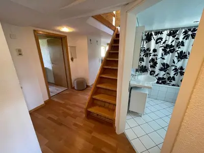 a bathroom with a staircase leading to a sink at Apartment Wartheim by Interhome in Heiden