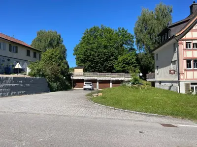 a car parked in a parking lot next to a building at Apartment Wartheim by Interhome in Heiden