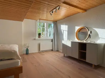 a bedroom with a mirror and a bed and a window at Apartment Wartheim by Interhome in Heiden