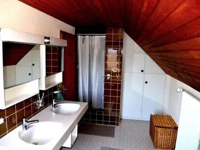 a bathroom with two sinks and a shower at Holiday Home See in Sicht by Interhome in Wolfhalden