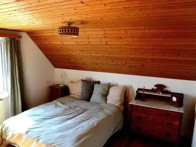 a bedroom with a bed with a wooden ceiling at Holiday Home See in Sicht by Interhome in Wolfhalden
