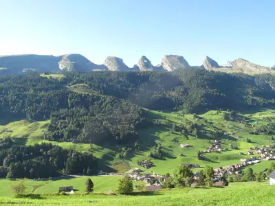 a green valley with mountains in the background at Apartment Gubel by Interhome in Alt Sankt Johann