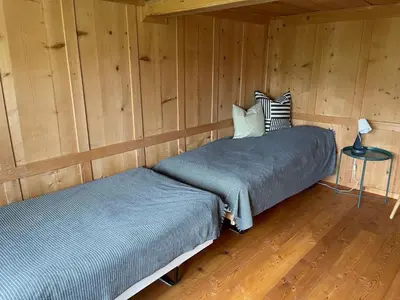 a bedroom with two beds in a wooden cabin at Holiday Home Bijou in Unterwasser by Interhome in Unterwasser