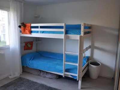 a bedroom with two bunk beds with blue sheets at Apartment Bergsicht by Interhome in Wildhaus