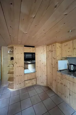 a kitchen with wooden walls and a counter top at Apartment Sweet Home by Interhome in Wildhaus
