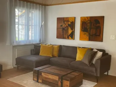a living room with a couch and paintings on the wall at Apartment Friedegg by Interhome in Wildhaus