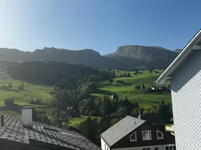 a view of a green valley with houses and mountains at Apartment Friedegg by Interhome in Wildhaus