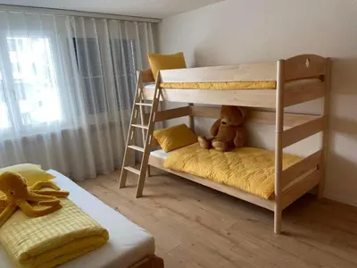 a bedroom with two bunk beds with a teddy bear at Apartment Friedegg by Interhome in Wildhaus