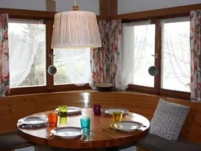 a wooden table with plates of food on top of it at Holiday Home MECK-HEI by Interhome in Wildhaus