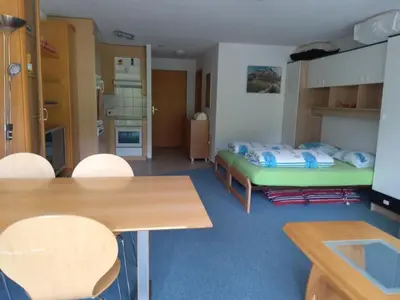 a room with a bed and a table and chairs at Apartment Studio Friedegg by Interhome in Wildhaus