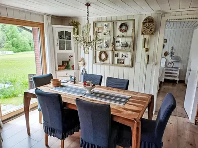 a dining room with a wooden table and chairs at Holiday Home Chalet Chic-Hot Pot by Interhome in Wildhaus