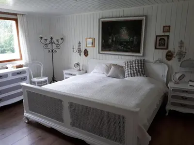 a bedroom with a large white bed and a window at Holiday Home Chalet Chic-Hot Pot by Interhome in Wildhaus