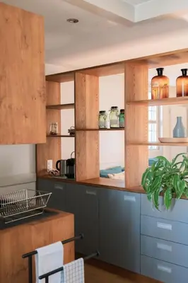 a kitchen with wooden cabinets with a plant in it at Apartment Studio Ferienwohnung - 38 m2- mit Gartennutzung by Interhome in Bottighofen